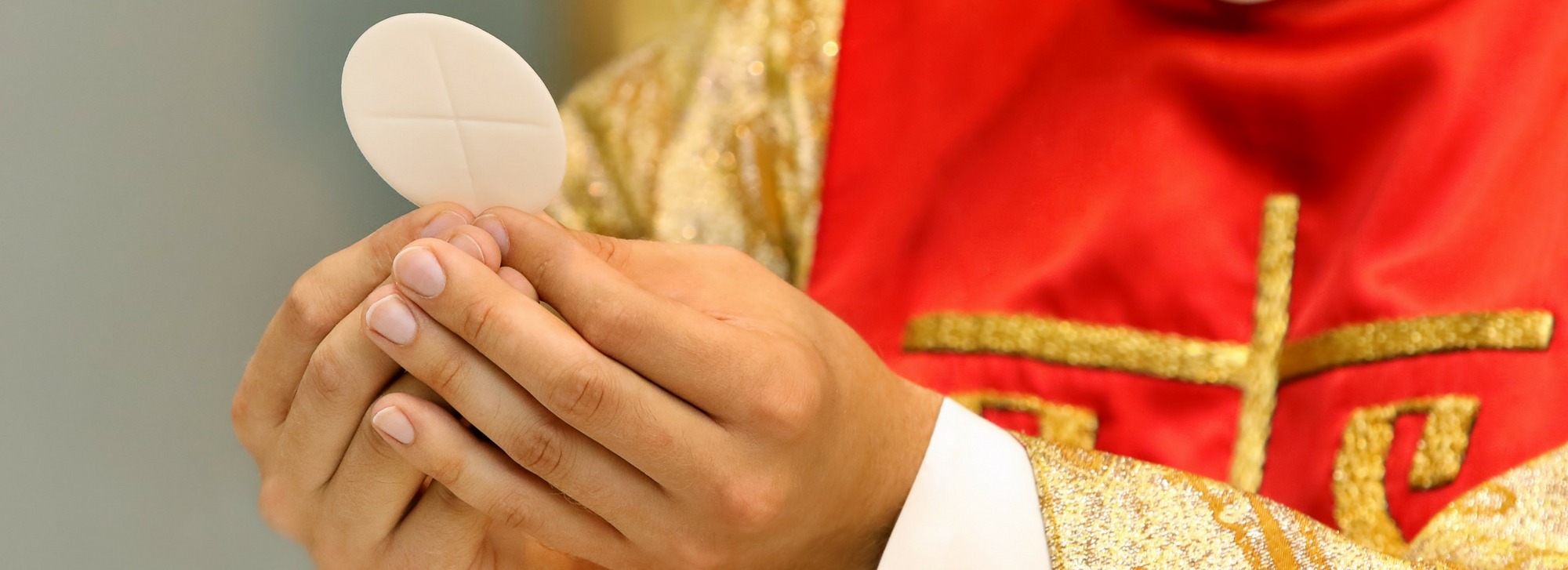 Priest Holding the Eucharist
