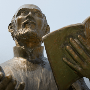 Statue of Ignatius of Loyola preaching with open Bible