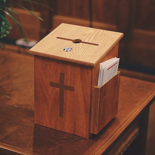 Wooden tithe box with a cross on the front
