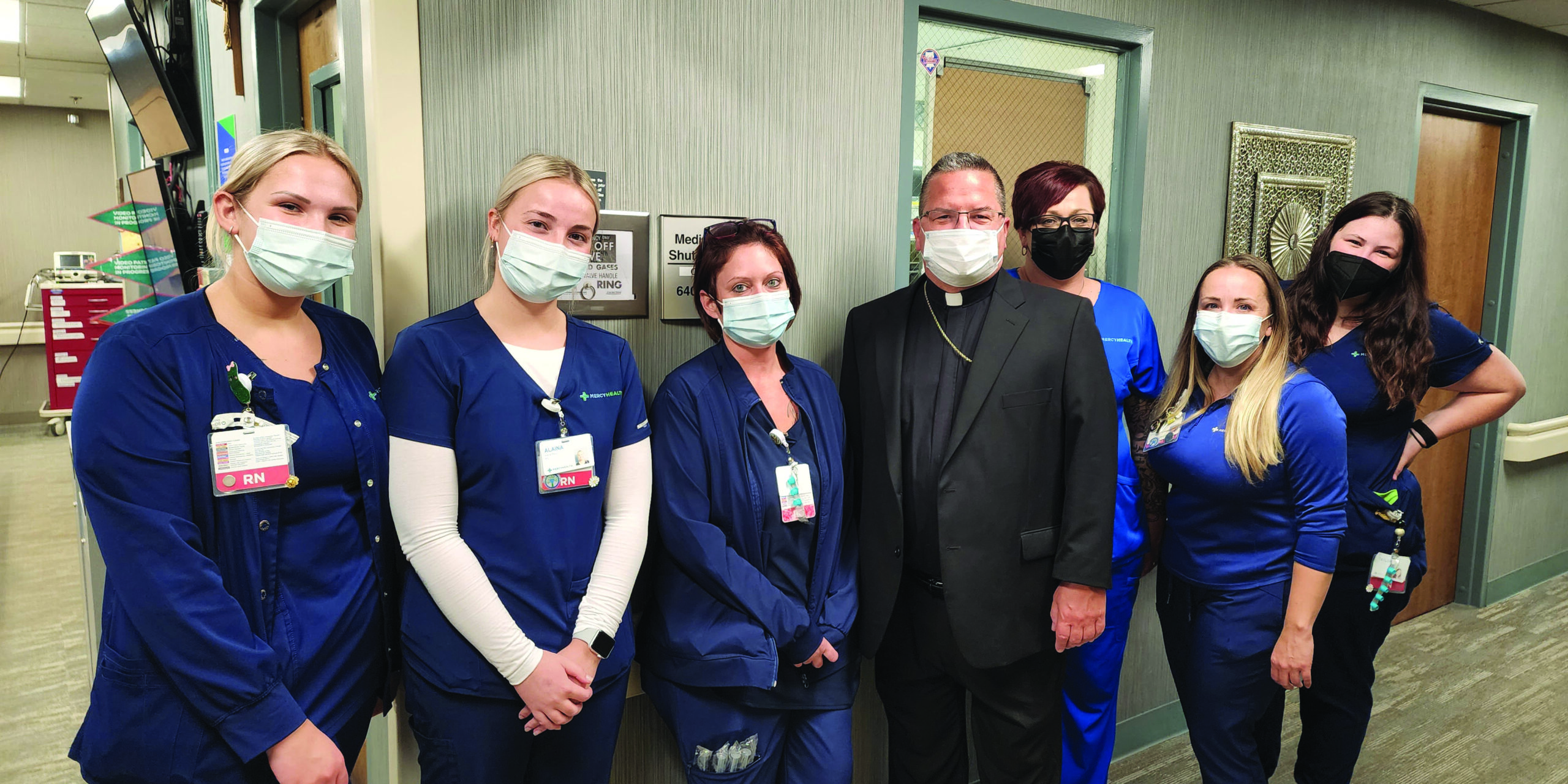 Bishop Bonnar with healthcare professionals at St. Elizabeth Hospital, Youngstown. Photo by Justin Huyck.