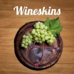 Grapes and wineskin on a wooden wine barrel