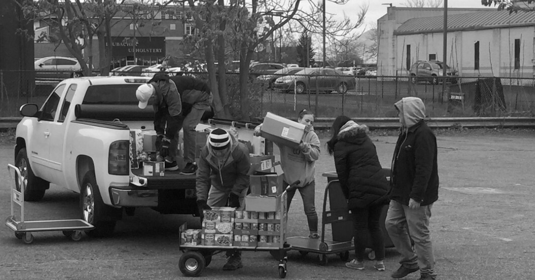 Volunteers working, unloading food