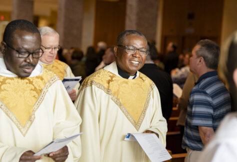 Priests smiling and singing