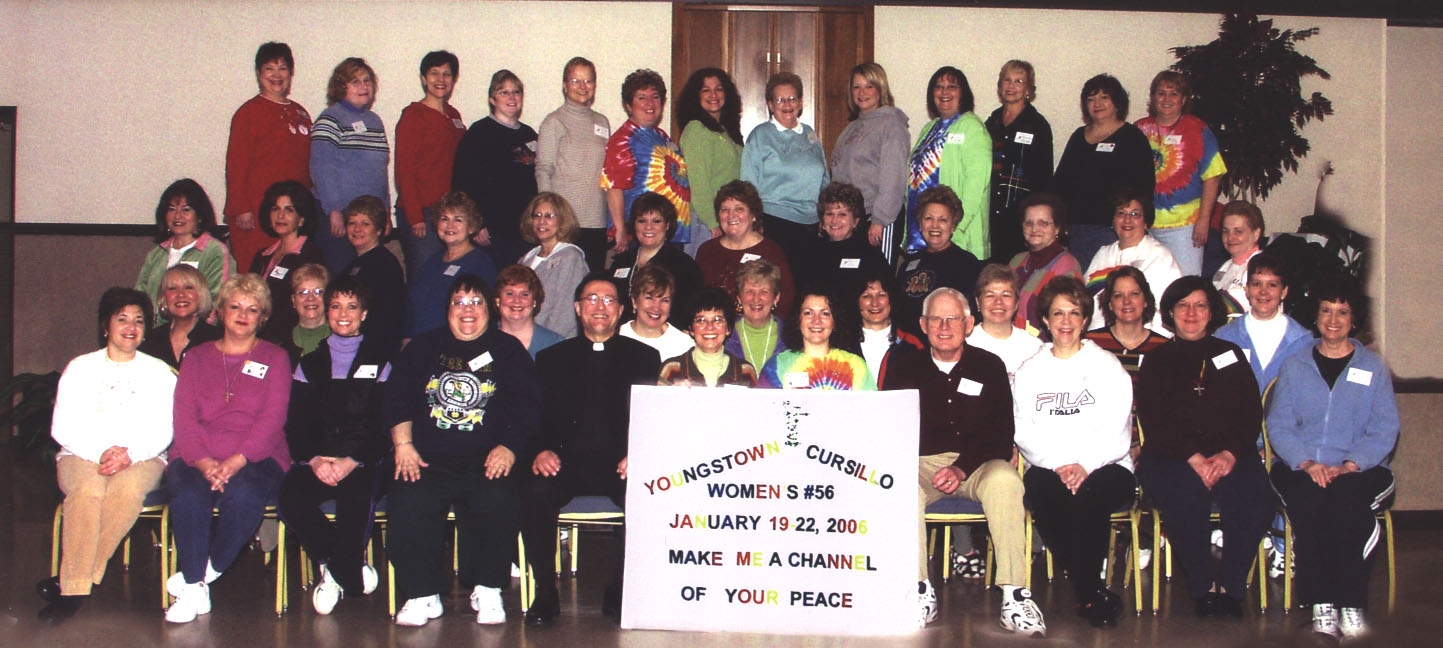 Three rows of smiling women. Sign reads: "Youngstown Cursillo Women's #56. January 19-22, 2006. Make me a channel of your peace."