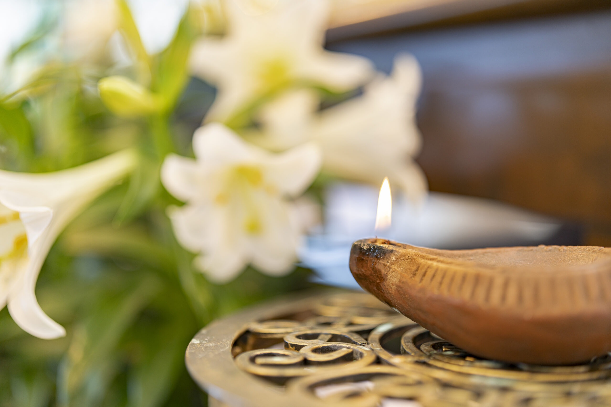 Lilies and oil lamp at the celebration of Religious Jubilees on April 13, 2024 at Blessed Sacrament Parish in Warren, Ohio
