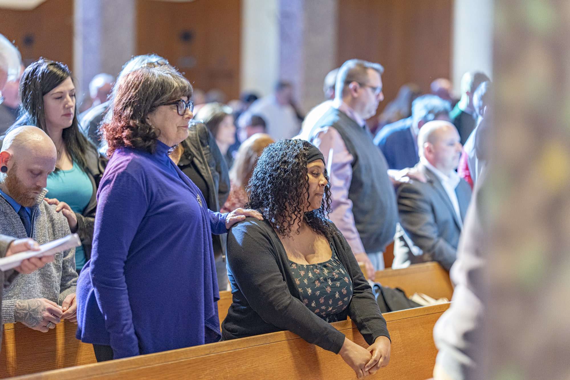 Sponsor has her hand on candidate's right shoulder at the Rite of Election, St. Columba Cathedral, February 18, 2024. Photo credit: Brian Keith.