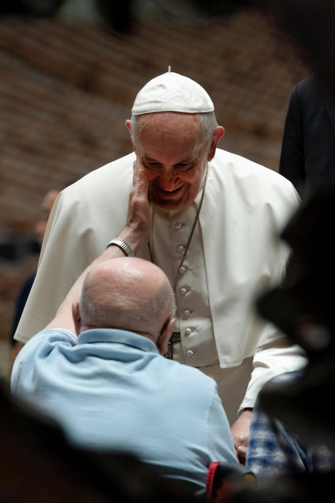A man touches the cheek of Pope Francis during the pontiff's general audience in St. Peter's Square at the Vatican June 26, 2019. Pope Francis, formerly Argentine Cardinal Jorge Mario Bergoglio, died April 21, 2025, at age 88.