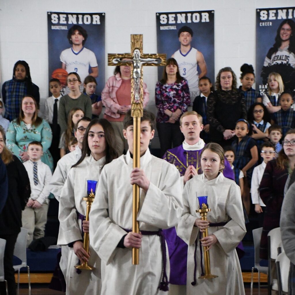 Servers wearing white and carrying cross and purple candles for Ash Wednesday