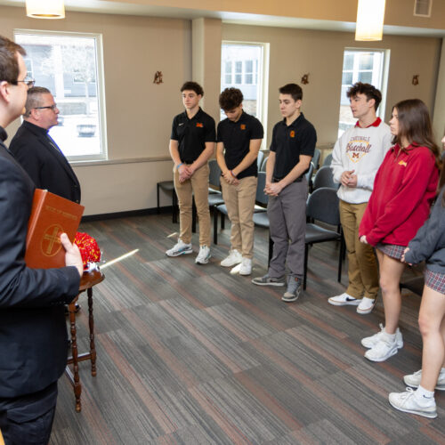 Rev. John Rovnak and Bishop David Connar speak with students at Cardinal Mooney High School