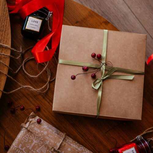 A wrapped present sitting on top of a wooden table